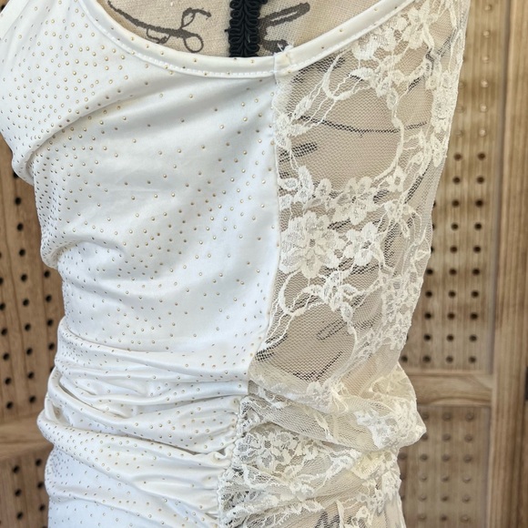 Cream color sleeveless top.Has Gold color Dots and a lace see through back. - Picture 8 of 8